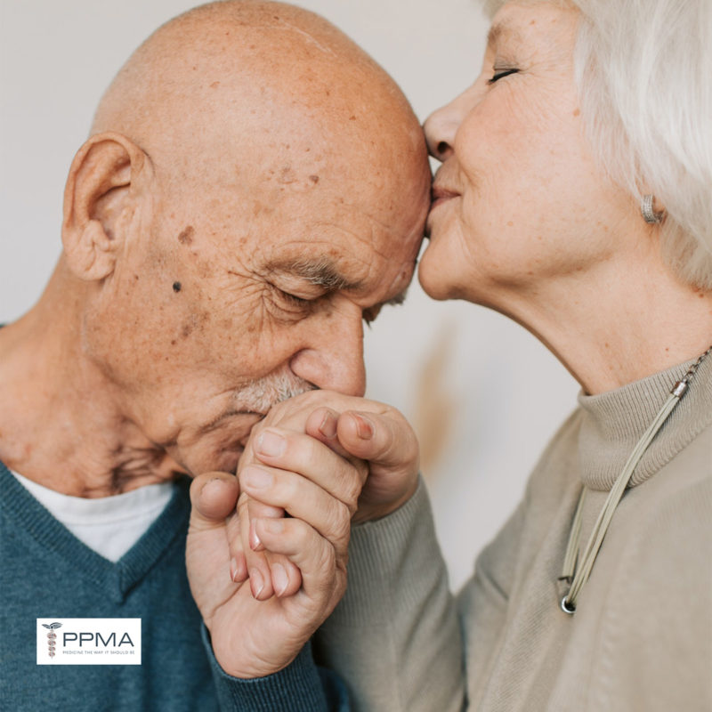 memory screening, memory loss, Alzheimer’s disease, mid-age senior couple kissing head and forehead