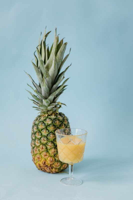 image of whole fresh pineapple glass of pineapple juice blue background nutrition ppma