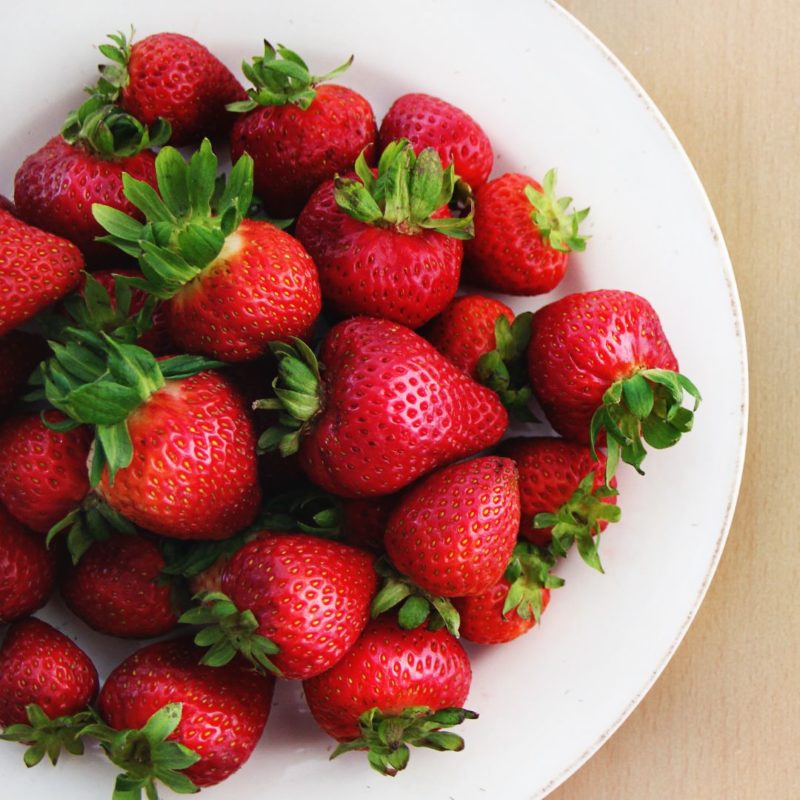Image of fresh strawberries with green stems on a white plate healthy recipe strawberry ppma private physicians medical associates