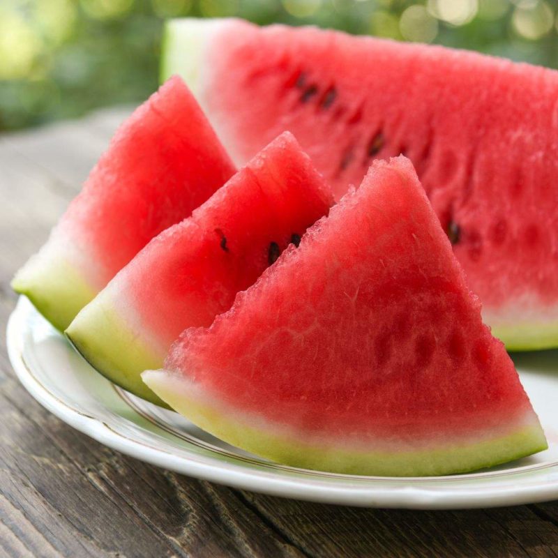 Image of sliced watermelon on a white plate outside on a picnic table to promote fresh fruit smoothie healthy recipe ppma private physicians medical associates