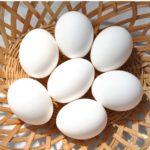 Image of 7 white eggs in a wicker basket, seen from above nutritionist ppma