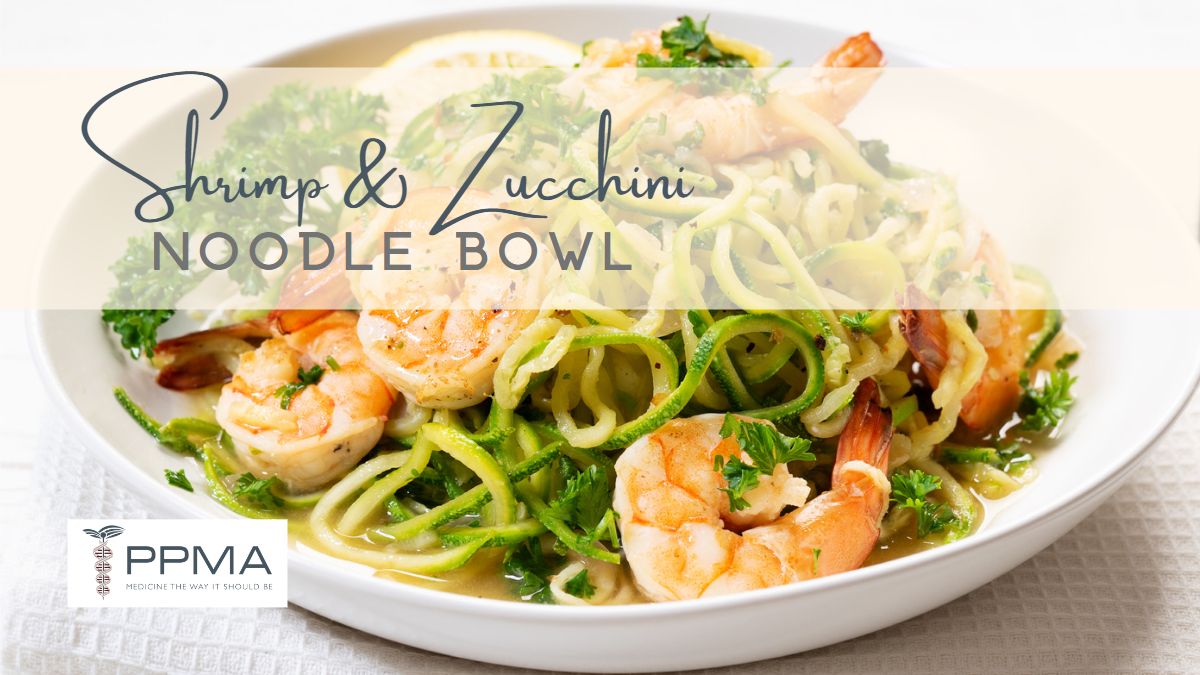 Image of plated Shrimp & Zucchini Noodle Bowl on white plate including zucchini noodles zoodles and shrimp and parsley for healthy recipe nutritionist PPMA