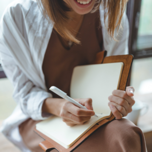 Image shows closeup of woman writing in journal on her lap for sleep diary PPMA private physicians medical associates healthcare