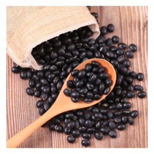 Image of uncooked black beans spilling out burlap sack on wooden table with wooden spoon. PPMA private physicians medical associates