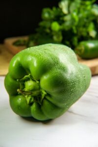 Closeup image of a green bell pepper with others in the background PPMA private physicians medical associates