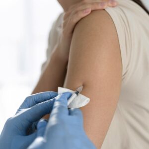 Image of person receiving flu shot from healthcare worker wearing blue gloves. Prep for Flu Season NOW PPMA. Private Physicians Medical Associates