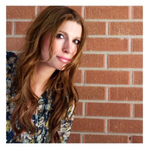 Image of red-haired woman in a rush, walking past a brick wall. quick tips for health. PPMA. private physicians medical associates