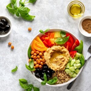 An image of a Buddha bowl, an example of a Mediterranean diet, with olives, garbanzo beans, fresh vegetables. Marching Towards Heart Health