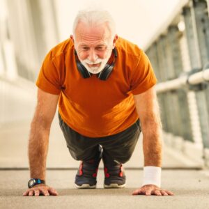 An older man doing push-ups as part of High-intensity interval training (HIIT)