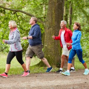 A group of seniors/middle-aged adults exercise-walking
