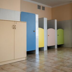 An image of colorful bathroom doors - blue, yellow, pink, and green.