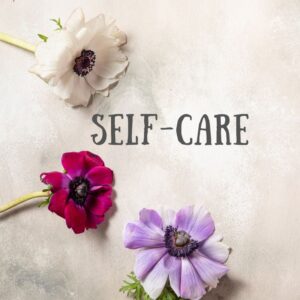 A graphic with three plucked flowers - white, red, and lavender- with the words "SELF-CARE" in the center.