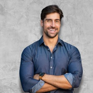 Image of a handsome, bearded adult man, arms crossed, smiling at the camera.