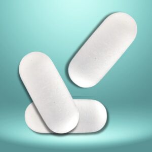 An image of three white medicinal capsules