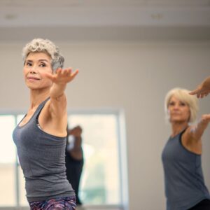 An image of middle-aged or senior women stretching in an exercise class