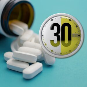 An image of a bottle of pills on its side with white capsules pouring out against a blue background. In the foreground is a timer alerting "30 min" time. Take your meds