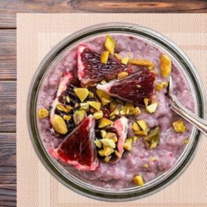 An image of a serving of Blood Orange & Pistachio Chia Pudding with a spoon.