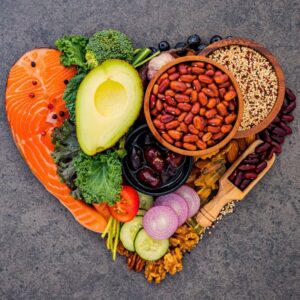 A heart shaped from antioxidant-rich foods, like salmon, avocado, beans, nuts, seeds, etc.