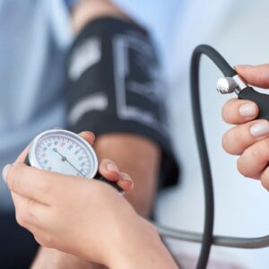 An image of someone checking a patient's blood pressure.