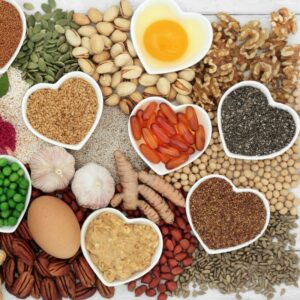 Cholesterol-healthy foods in heart-shaped bowls