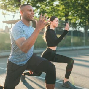 Image of a couple exercising outside. Physical activity is a great partner with a nutritious diet.