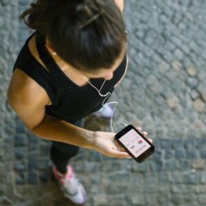 Woman uses technology to enhance her exercise routine.