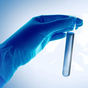 Scientist's hand holding test tube.