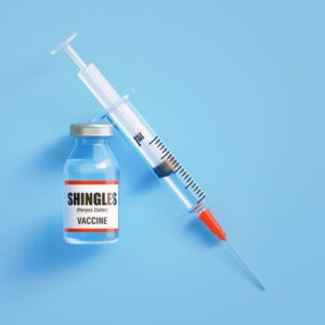 The herpes zoster (aka shingles) vaccination on a blue background.
