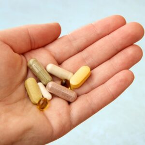 Supplements in a person's hand.