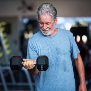 Senior man strength training at the gym
