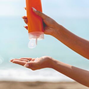 Person using sunscreen at the beach