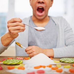 Man eating piles of sugar